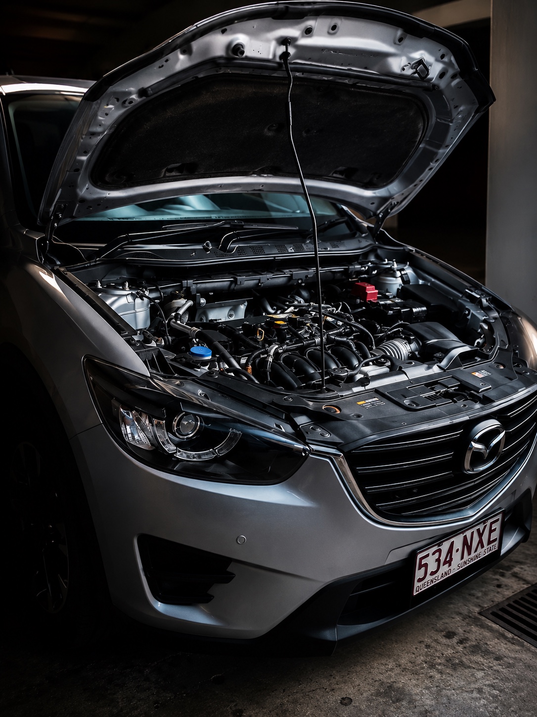 Vehicle with bonnet open during workshop inspection